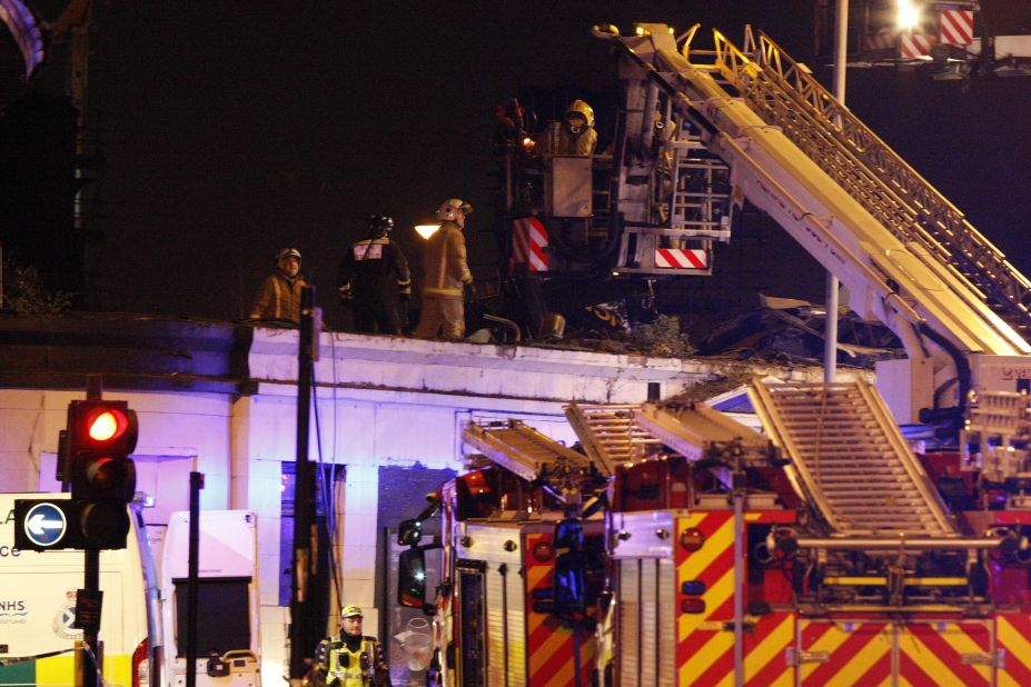 The helicopter, carrying two police officers and a civilian pilot, crashed on the roof of the pub at 10:25 p.m., according to Scottish police. 