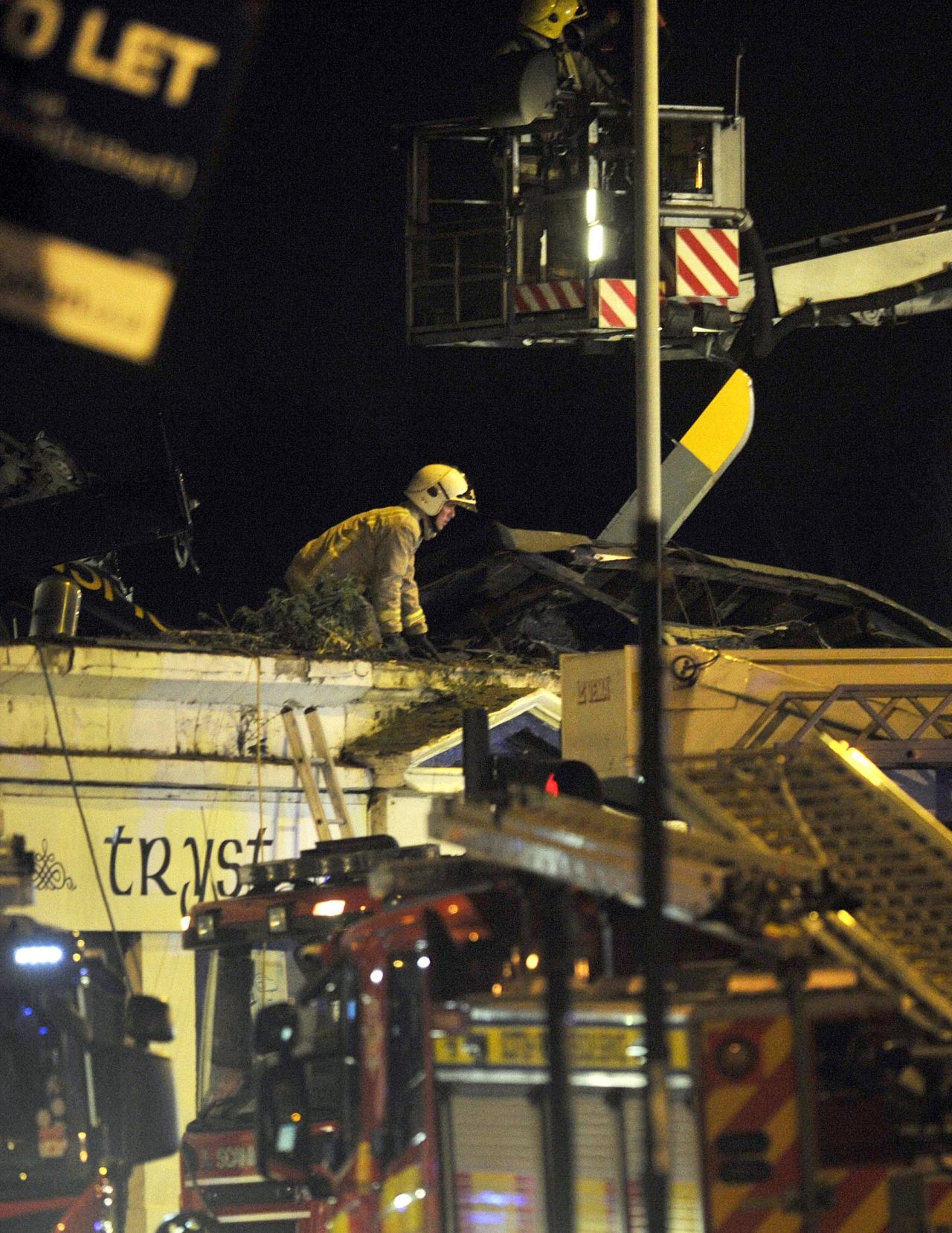 Emergency workers inspect the roof of the pub.