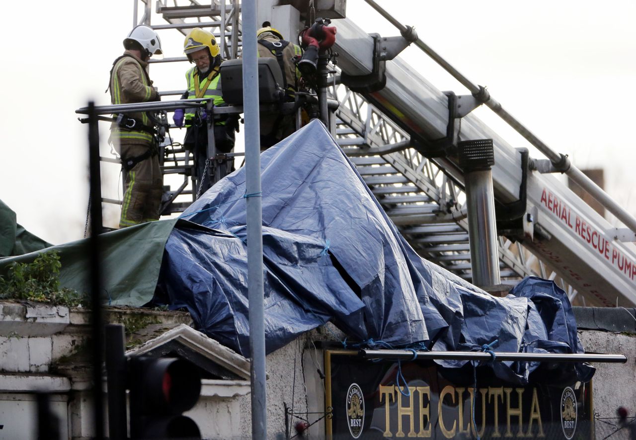 Emergency workers sift through wreckage.