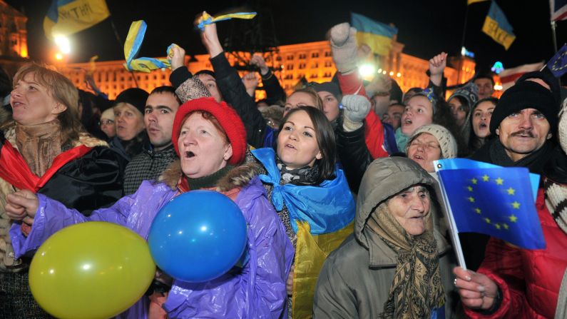 Opposition supporters shout slogans and wave flags on November 29.