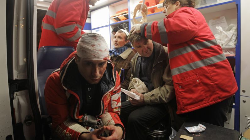 Injured protesters receive medical help in an ambulance after riot police broke up a rally on November 30.