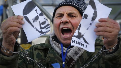 A demonstrator holds a torn portrait of Yanukovych on November 29.