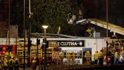 Rescue workers attend the scene at a pub on Stockwell Street where a police helicopter crashed on the banks of the River Clyde November 30, 2013 in Glasgow, Scotland.