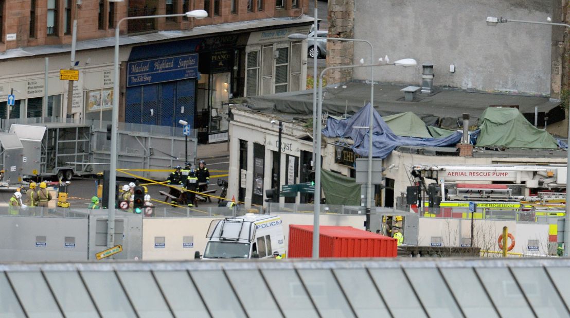 Rescue workers in Glasgow, Scotland, tend to the scene Saturday, November 30, where a police helicopter crashed into the Clutha Bar.