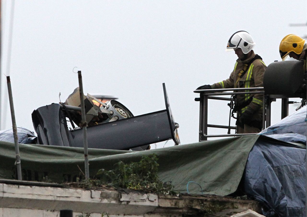The damaged helicopter rests on the roof of the Clutha Bar.
