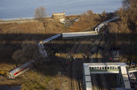 First responders gather around the derailment on December 1. Of eight train cars, seven were off the tracks.