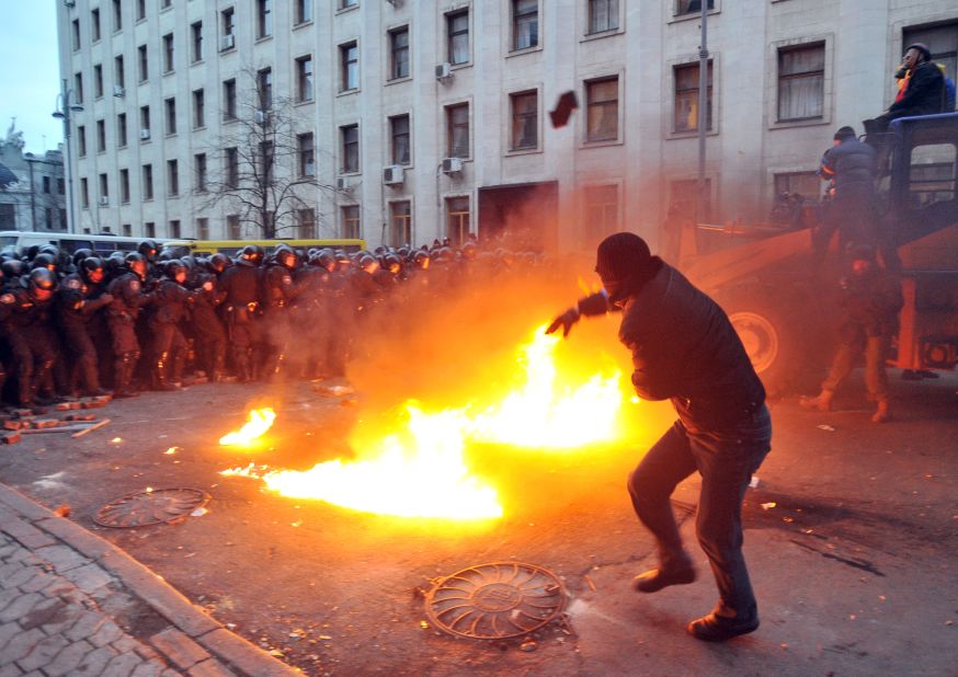 A protester throws stones toward riot police on December 1. The crowd chanted "Revolution" and "Down with the Gang" as it gathered in Independence Square.