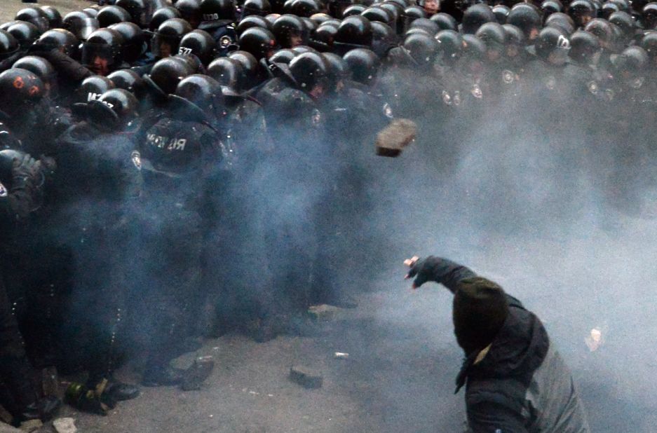 A Ukrainian protester throws stones at riot police during clashes outside the president's office on December 1.