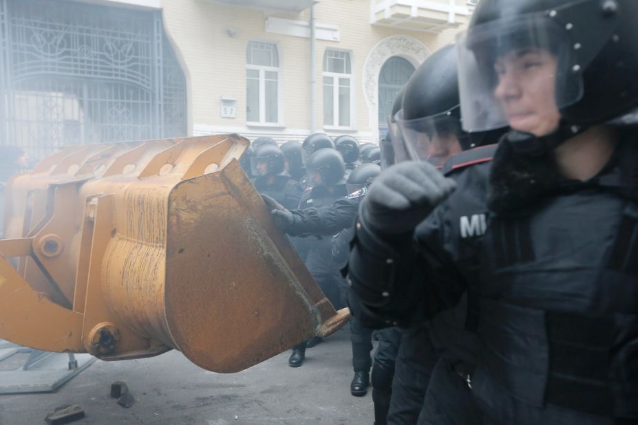 Protesters use a bulldozer during clashes with police at the presidential office in Kiev on December 1.
