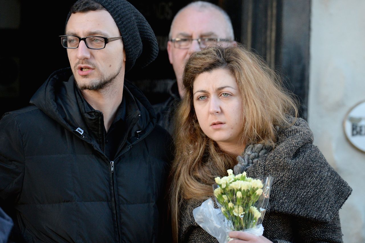 Members of the public wait on Sunday to lay flowers near to the Clutha pub in Glasgow.