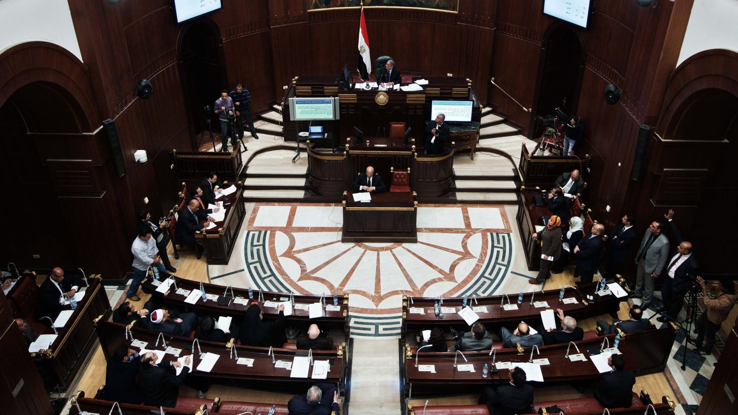 Members of the Egyptian constitutional panel vote on a new constitution at the Shura council in Cairo.