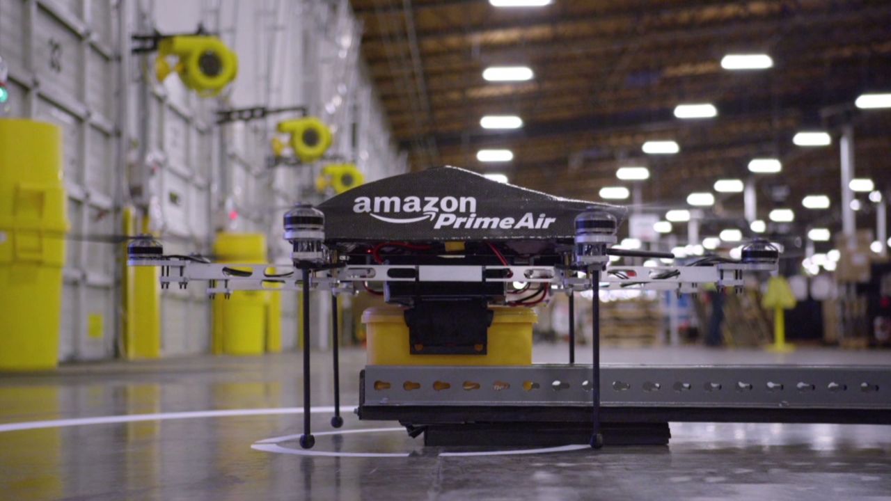 This Amazon video shows a drone picking up a package at a warehouse.
