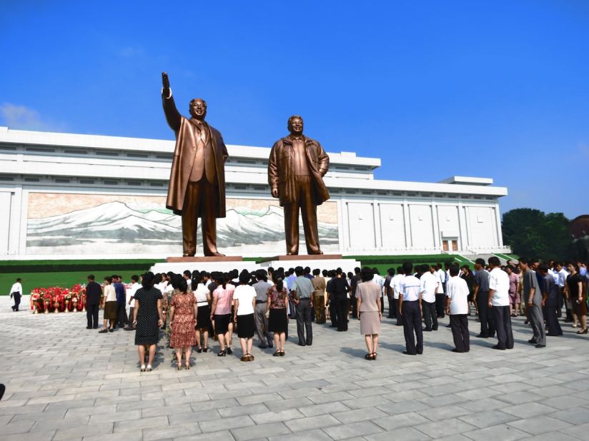 Statues of Kim Il Sung (left) and Kim Jong Il (right) at Mansudae in Pyongyang. North Koreans gather in front of the statues to lay flowers and bow, showing their respect for the late and current leader. Tourists visiting North Korea are expected to do the same. 