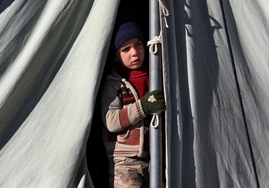 A Syrian child looks out from his tent at a refugee camp in Arsal on Friday, November 29.