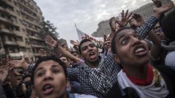 Cairo University's students backing ousted Islamist president Mohamed Morsi shout slogans during a demonstration against July's military 'coup,' in Tahrir square on December 1, 2013 in Cairo, Egypt. Protesters were chanting 'Down with the military regime!', 'People want the fall of the regime!' and 'Rabaa Rabaa', an AFP reporter said, as demonstrators flashed a four-finger sign that has become associated with a government crackdown on pro-Morsi supporters in Cairo's Rabaa al-Adawiya square on August 14. AFP PHOTO/MAHMOUD KHALED (Photo credit should read MAHMOUD KHALED/AFP/Getty Images)