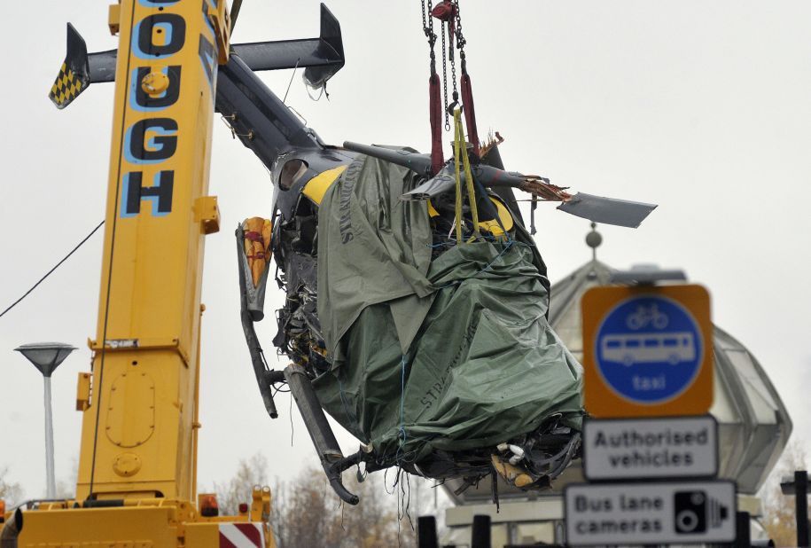 The wreckage of a police helicopter is lifted from the collapsed roof of Clutha pub in Glasgow on Tuesday, December 2. Eight people have been killed and 14 seriously injured since a police aircraft crashed into a downtown pub.