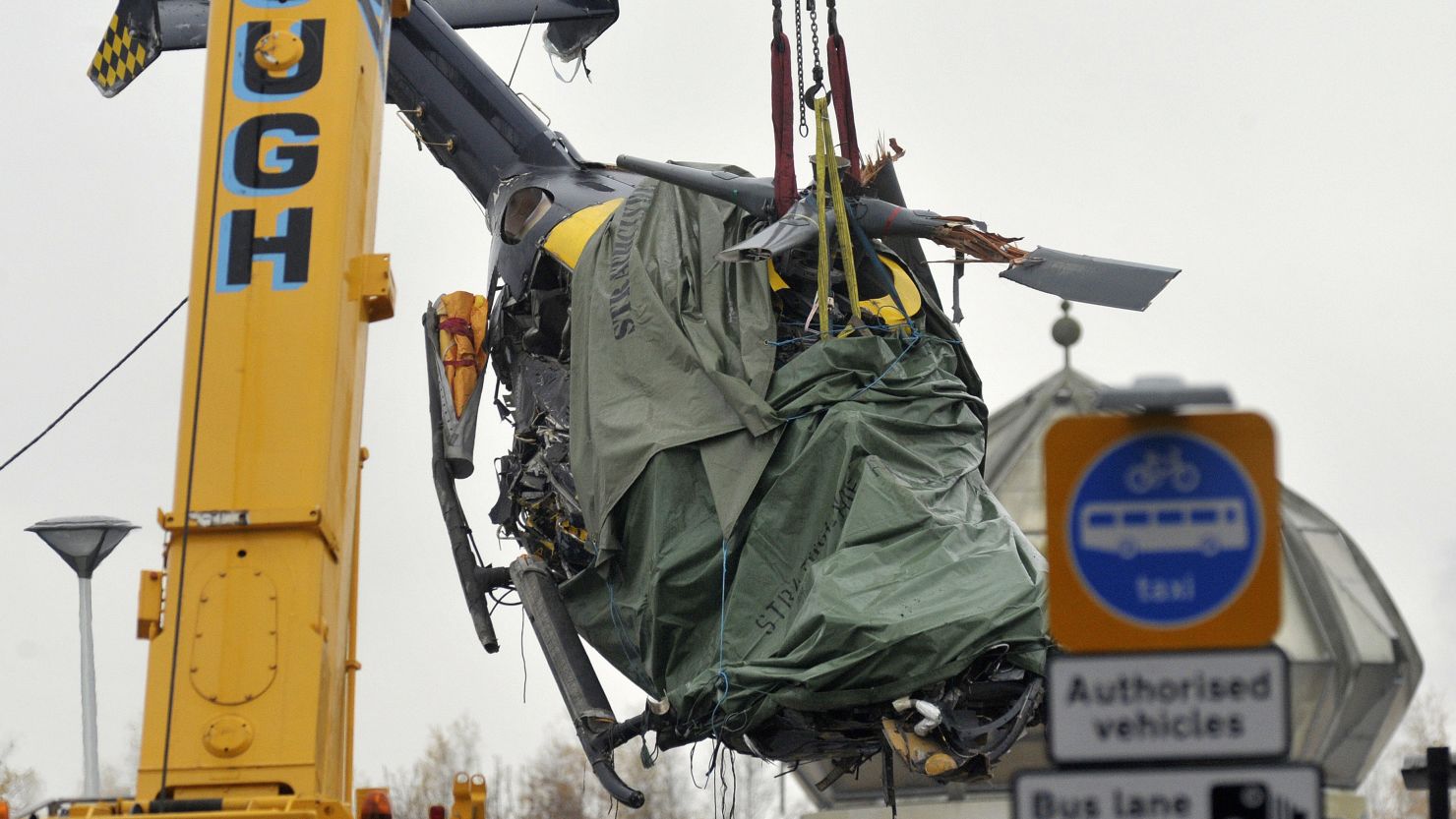 The wreckage of a police helicopter is winched from the collapsed roof of a pub in Glasgow on December 2, 2013. 