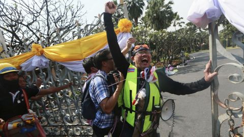 A protester celebrates after opening the gate of Government House on December 3.