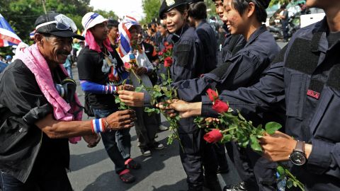 Protesters receive flowers from police officers on December 3.
