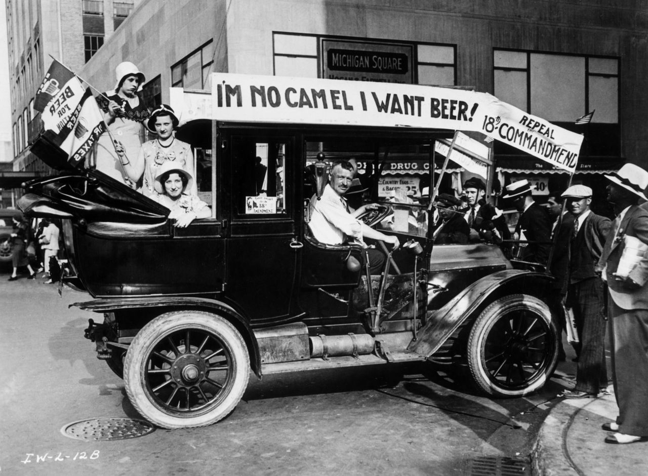 Prohibition protesters parade in a car emblazoned with signs and flags calling for the repeal of the 18th Amendment in 1923.