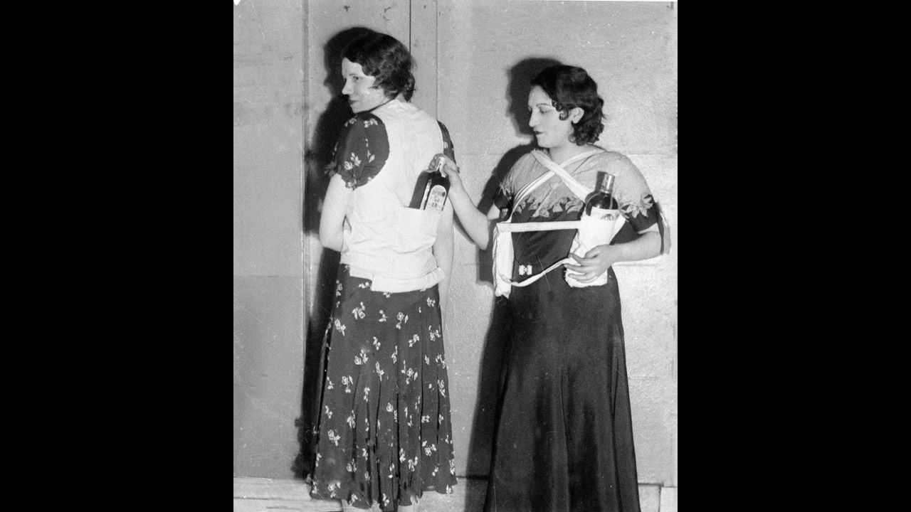 Estelle Zemon, left, and an unidentified woman model ways to conceal bottles of rum to get past customs officials on March 18, 1931. Cocktails grew in popularity during Prohibition as the juices and other mixers covered the taste of the sometimes less-than-premium alcohol.