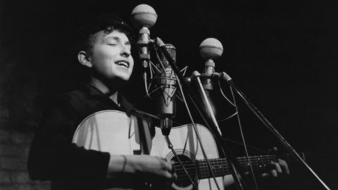 Dylan performs in 1961 at The Bitter End club in New York City. His first album, "Bob Dylan," debuted in 1962 and consisted mostly of old folk songs.