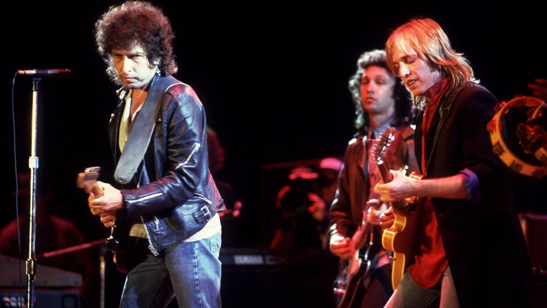 Dylan performs with Tom Petty at Farm Aid in Chicago in 1985.