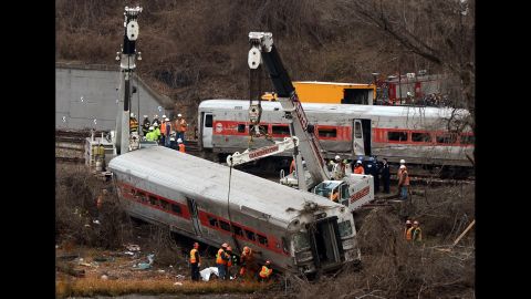 Cranes lift derailed train cars on Monday, December 2.