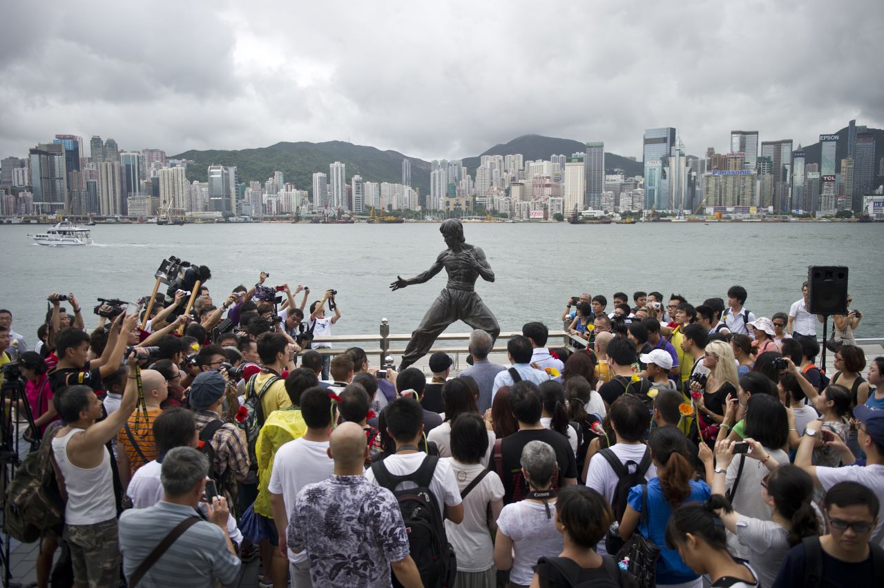 Fans gather around a statue of Bruce Lee in Hong Kong to mark the 40th anniversary of his death on July 20, 2013. Hailed as cinema's first martial arts hero and a cinematic bridge between the cultures of East and West, Bruce Lee helped put Hong Kong on the world movie map.