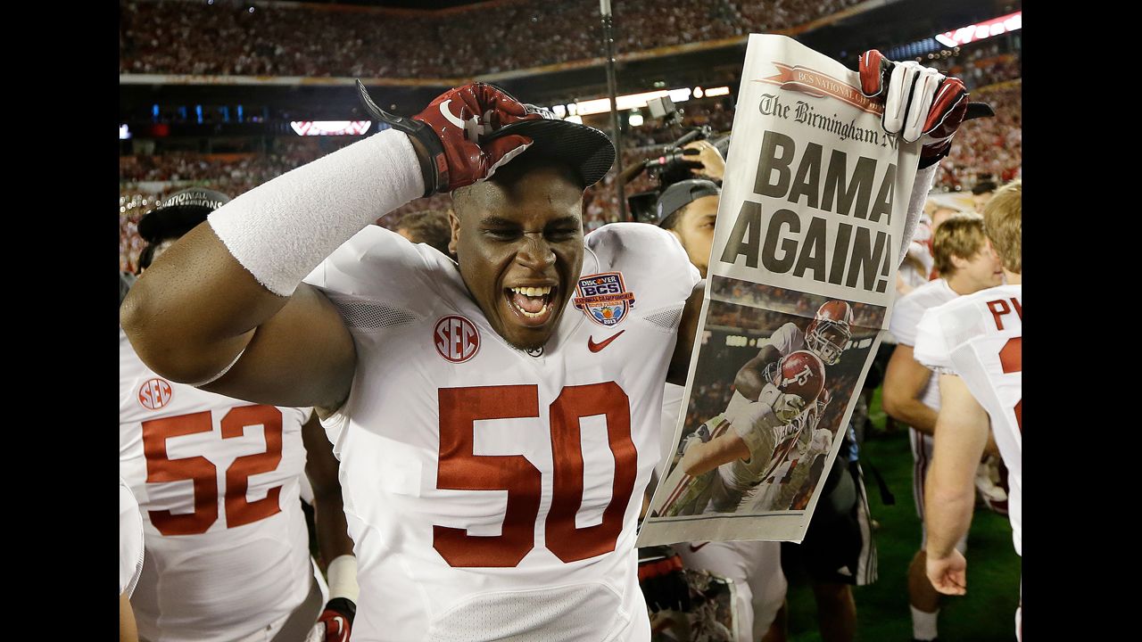 <strong>January 7:</strong> Alabama defensive lineman Alphonse Taylor holds up a newspaper after Alabama defeated Notre Dame 42-14 in the BCS National Championship game. It was the second straight national title for the Crimson Tide.