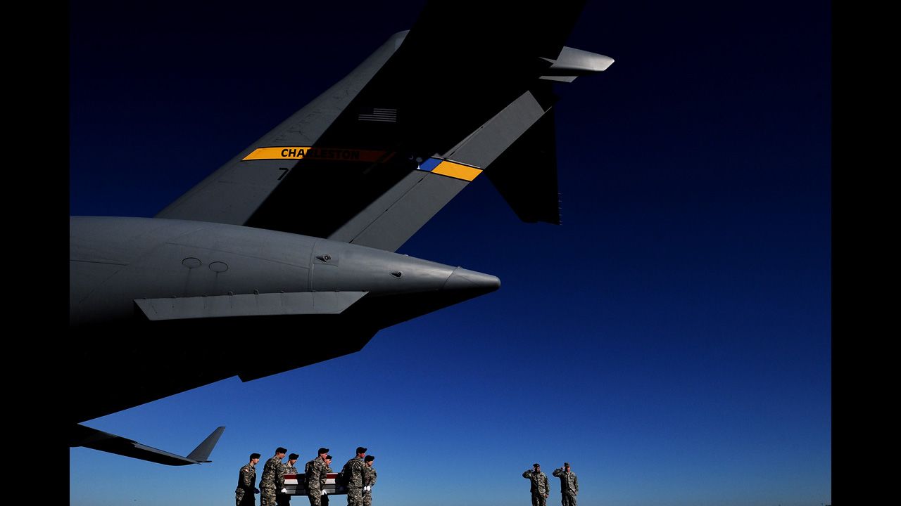 <strong>January 19:</strong> U.S. Army soldiers in Dover, Delaware, carry the flag-draped transfer case of Army Sgt. David J. Chambers, who was killed in Afghanistan.