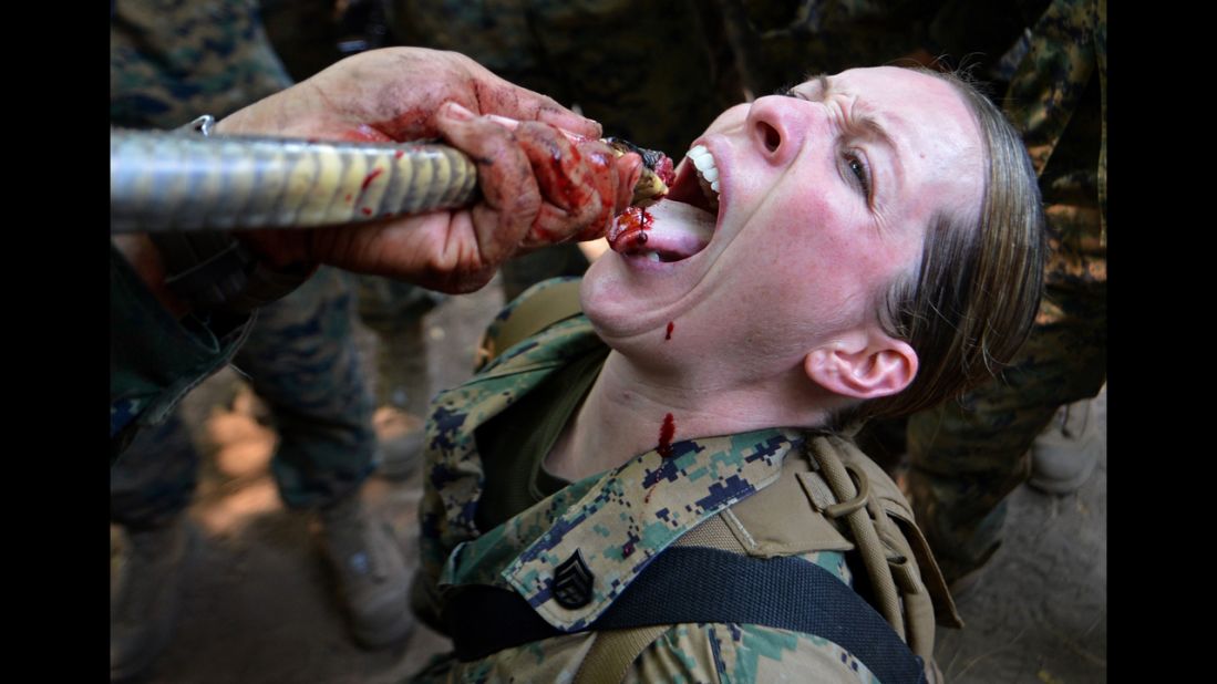 <strong>February 20:</strong> A U.S. Marine drinks cobra blood during a jungle survival program at a base in Sattahip, Thailand.
