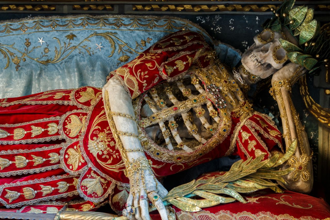 <em>St Konstantius displayed in a reclining position in Rohrshach, Switzerland</em><br /><br /><strong>CNN:</strong> <strong>Did the artisans ever leave offerings with the skeletons?</strong><br /><br /><strong>PK: </strong>It was definitely an honor to work on such skeletons, since it was a service to God. It is notable that many of the skeletons have rings on their bony fingers—often these rings were given to them by the very people who decorated them, as a way of leaving a lasting offering with the skeleton they had worked on, because it was a privilege to have been part of such a project.