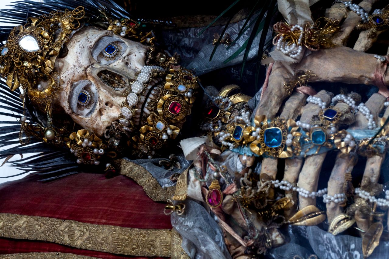 <em>St. Valerius at rest in in Weyarn, Germany</em><br /><br />When archaeologists unlocked the catacombs of Rome in 1578, they unleashed a wave of religious fervor. Catholic officials disinterred skeletal remains, which they assumed to be early Christian martyrs, and had artisans reassemble them. Encrusted with gold and jewels, the skeletons then went on display in lavish shrines across Europe to convey the glory that awaited the Church's devout followers in the afterlife. But by the early 19th century their saintly authenticity came into question and, in a dramatic reversal of fortune, many of the relics were hidden from view or destroyed.<br /><br />Photographer and author Paul Koudounaris gained unprecedented access to these so-called "catacomb saints" for his new book <a href="http://www.thamesandhudson.com/Heavenly_Bodies/9780500251959" target="_blank" target="_blank"><em>Heavenly Bodies</em></a><em>, </em>published by Thames and Hudson. Many had never been photographed for publication before. Revered as spiritual objects and then reviled as a source of embarrassment for the Church, their uneven history is marked by one constant: a mysterious, if unsettling, beauty. "I wanted to pursue this project to provide a new context for them," Koudounaris says, "and to look at them not as failed devotional items, but instead as fine objects of art.<br /><br />Interview by William Lee Adams