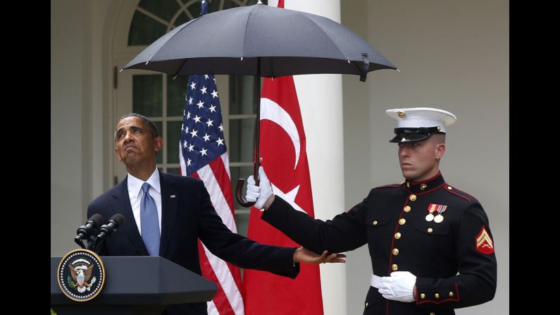 <strong>May 16:</strong> U.S. President Barack Obama looks to see if it is still raining as a Marine holds an umbrella for him during a news conference in the Rose Garden of the White House.