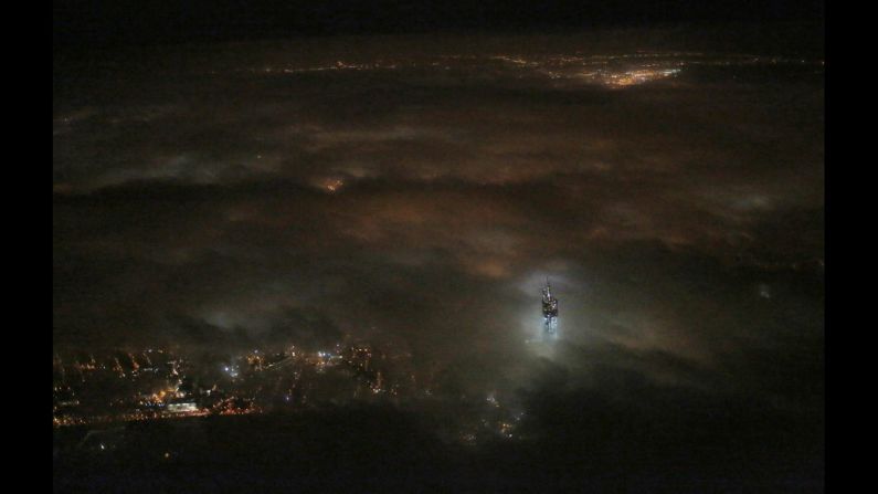 <strong>March 11:</strong> The One World Trade Center building emerges from the clouds in New York's night sky. Construction on the office complex, which is going up on the site of the original World Trade Center, is set to be completed in early 2014.