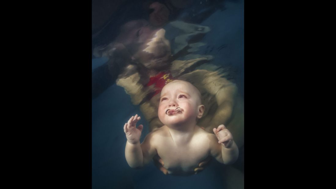 <strong>March 13:</strong> A baby is helped to swim in Kiev, Ukraine.