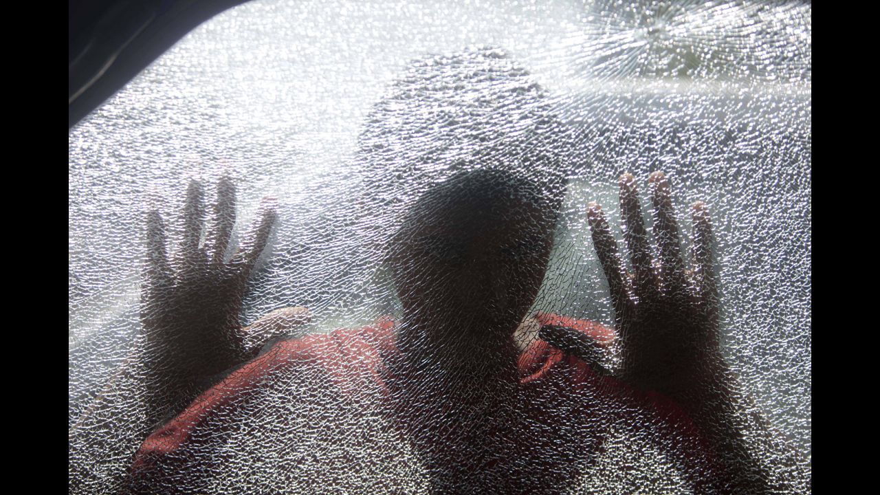 <strong>March 18:</strong> A Bangladeshi boy looks inside a car vandalized by activists of the Bangladesh Nationalist Party during a general strike in Dhaka, Bangladesh.