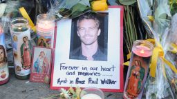 A photo of actor Paul Walker is seen December 1, 2013 among flowers and candles left by fans at the site of the car accident in which the 'Fast and Furious' actor and another man died the previous day, in Santa Clarita, California.