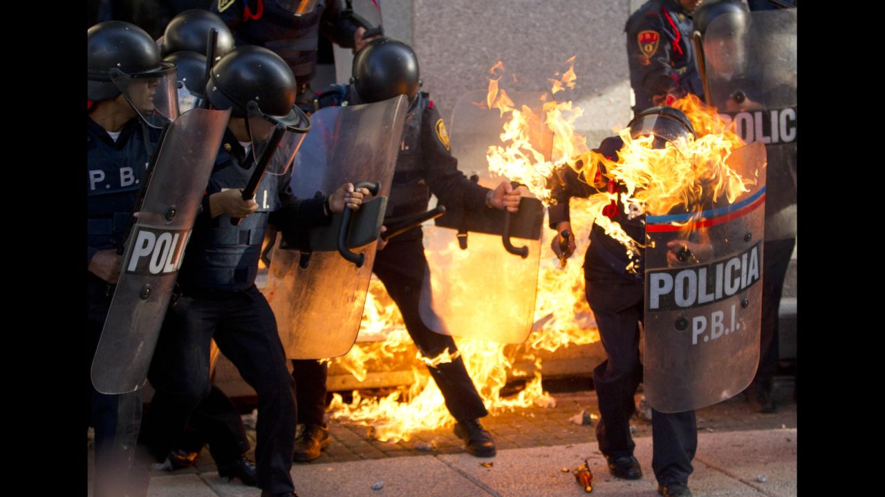 <strong>October 2:</strong> A police officer is engulfed in flames after being hit by a Molotov cocktail thrown by protesters marking the anniversary of the Tlatelolco massacre in Mexico City. 