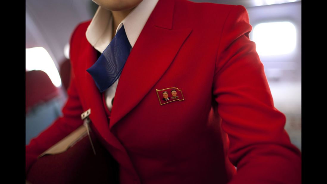 <strong>April 11:</strong> An Air Koryo attendant wears a pin showing portraits of the late North Korean leaders Kim Il Sung and Kim Jong Il. Air Koryo is the world's only 1-star airline on Skytrax, a consultancy that has ratings and reviews for more than 681 airlines.