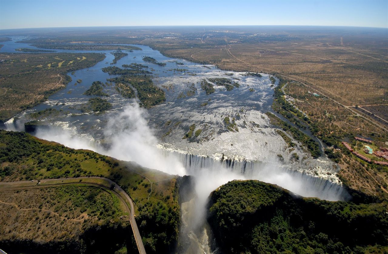 Victoria Falls has been called the backbone of Zimbabwe's tourism industry. The falls, which are over one mile wide, are known by the local Kololo tribe as Mosi oa Tunya, which means "The smoke that thunders." 