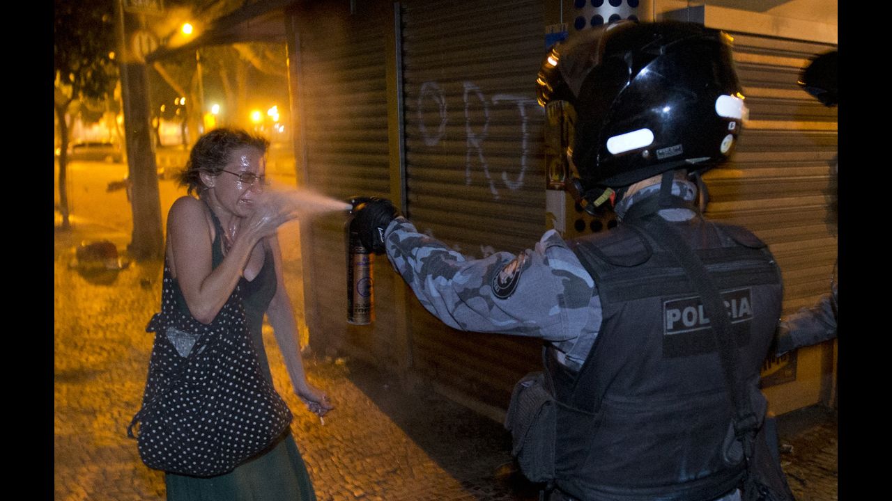 <strong>June 17:</strong> A military police officer pepper-sprays a protester in Rio de Janeiro. Millions of Brazilians took to the streets this summer to protest years of dissatisfaction and discontent with their government. 
