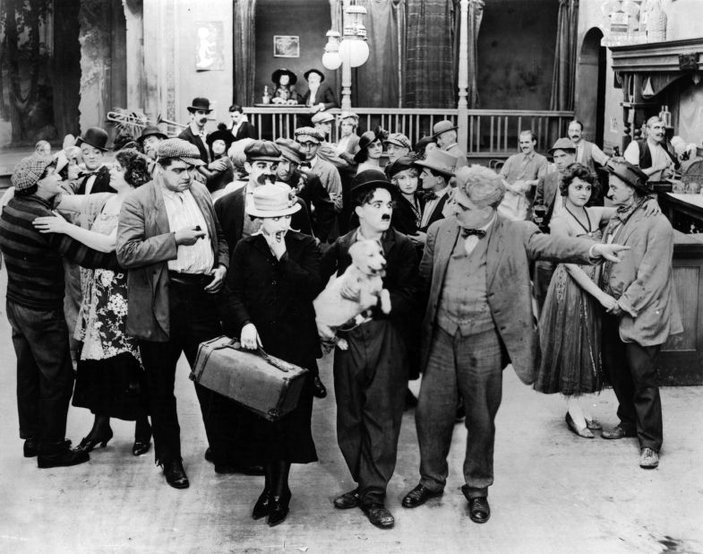 Here, Chaplin appears as the iconic "Tramp" in 1918 film "A Dog's Life." From humble beginnings growing up in an impoverished home and orphanages in London, Chaplin became one of the most famous film stars in the world. 