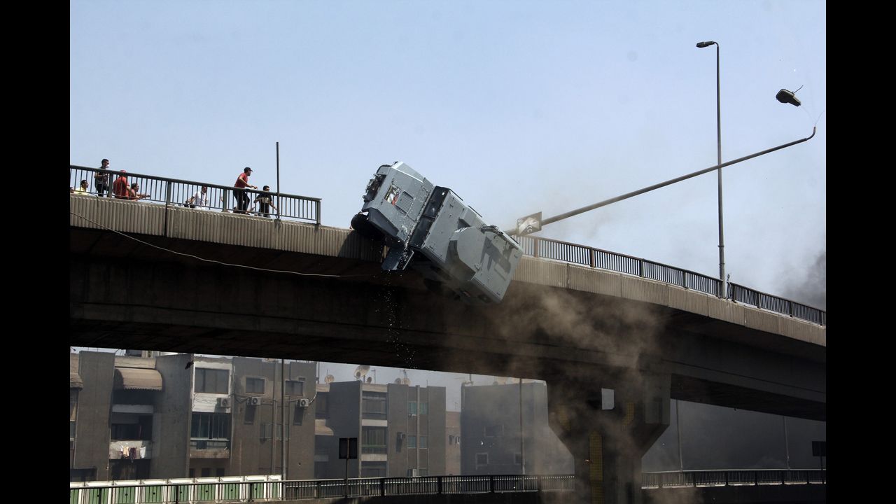 <strong>August 14:</strong> A police vehicle is pushed off the 6th October Bridge in Cairo by supporters of ousted Egyptian President Mohamed Morsy.