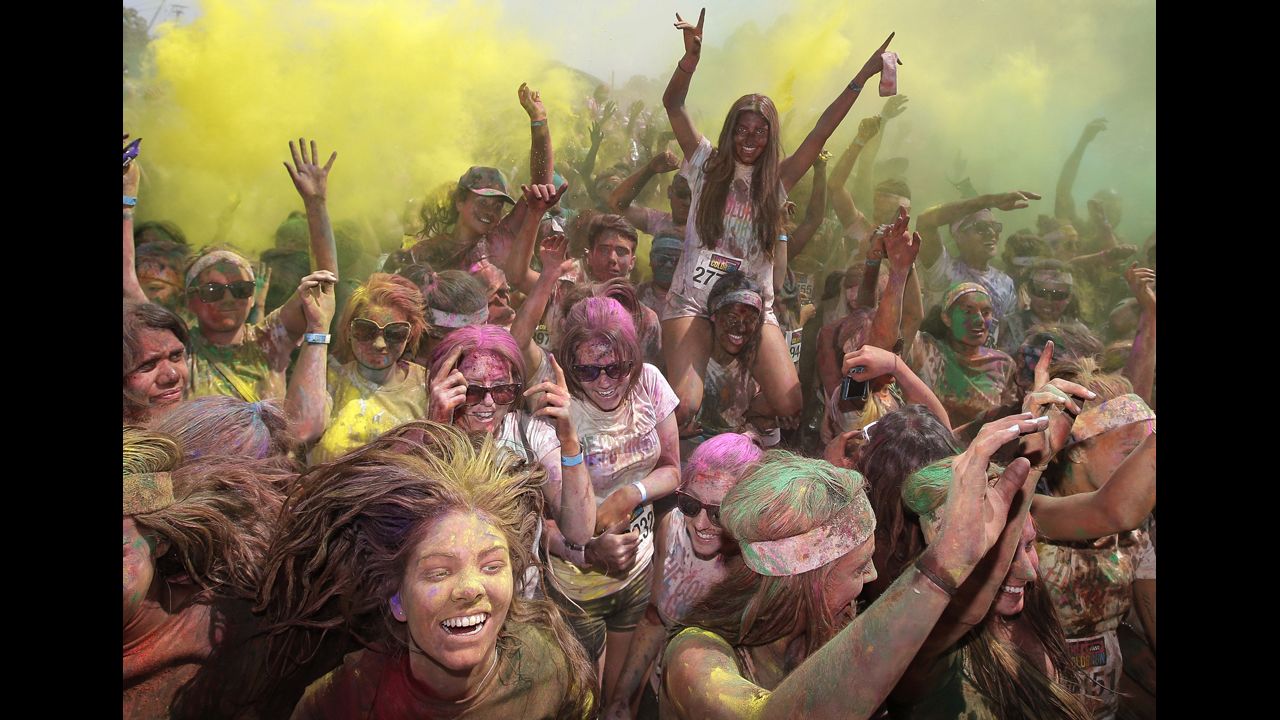 <strong>February 10:</strong> People celebrate in clouds of colored dust after the Color Run 5K in Sydney.