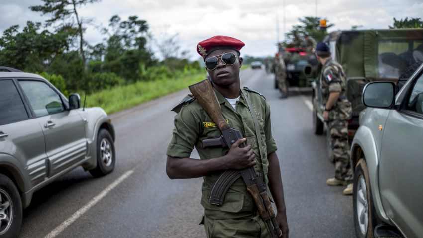 A Cameroonian soldier holds an assault rifle as Cameroonian military escort French troops driving from Douala to Central African Republic on December 4, 2013.