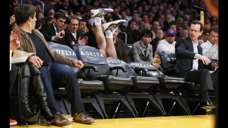 Steve Blake of the Los Angeles Lakers falls over empty courtside chairs trying to save a ball from going out of bounds during a game against the Phoenix Suns on February 12 in Los Angeles. The Lakers won 91-85.