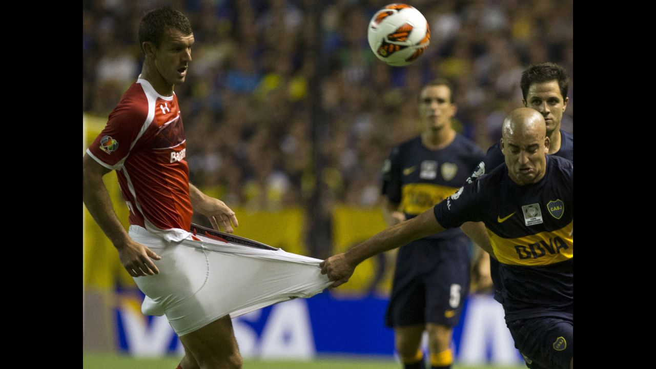 Santiago Silva of Argentina's Boca Juniors grabs Diego Novaretti of Mexico's Toluca during a Copa Libertadores soccer match in Buenos Aires, Argentina, on February 13.