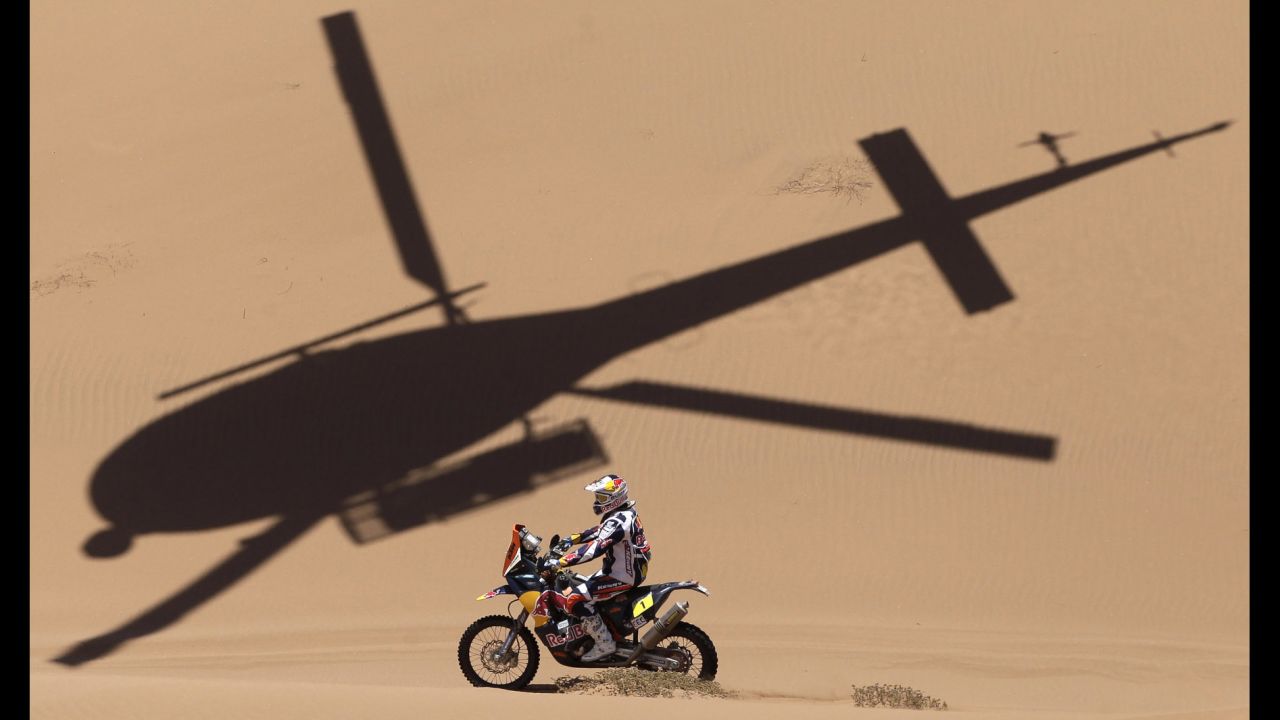 The shadow of a helicopter is projected over KTM rider Cyril Despres of France as he competes in the 2013 Dakar Rally on January 17. The event started on January 5 in Lima, Peru, and finished on January 19 in Santiago, Chile.